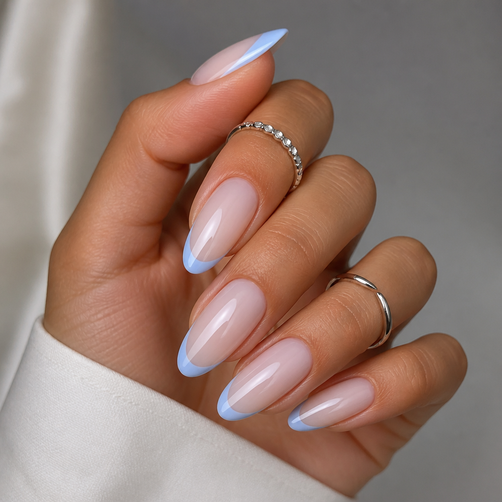 Long almond nails with sheer milky pink base and soft blueberry milk French tips