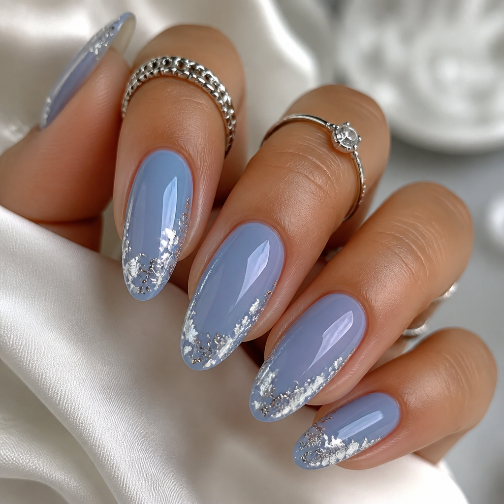 Glossy blueberry milk almond nails with delicate silver foil flakes