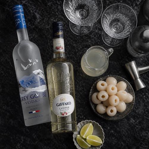 Ingredients for lychee martini including premium vodka, lychee liqueur, lychee syrup, and lime